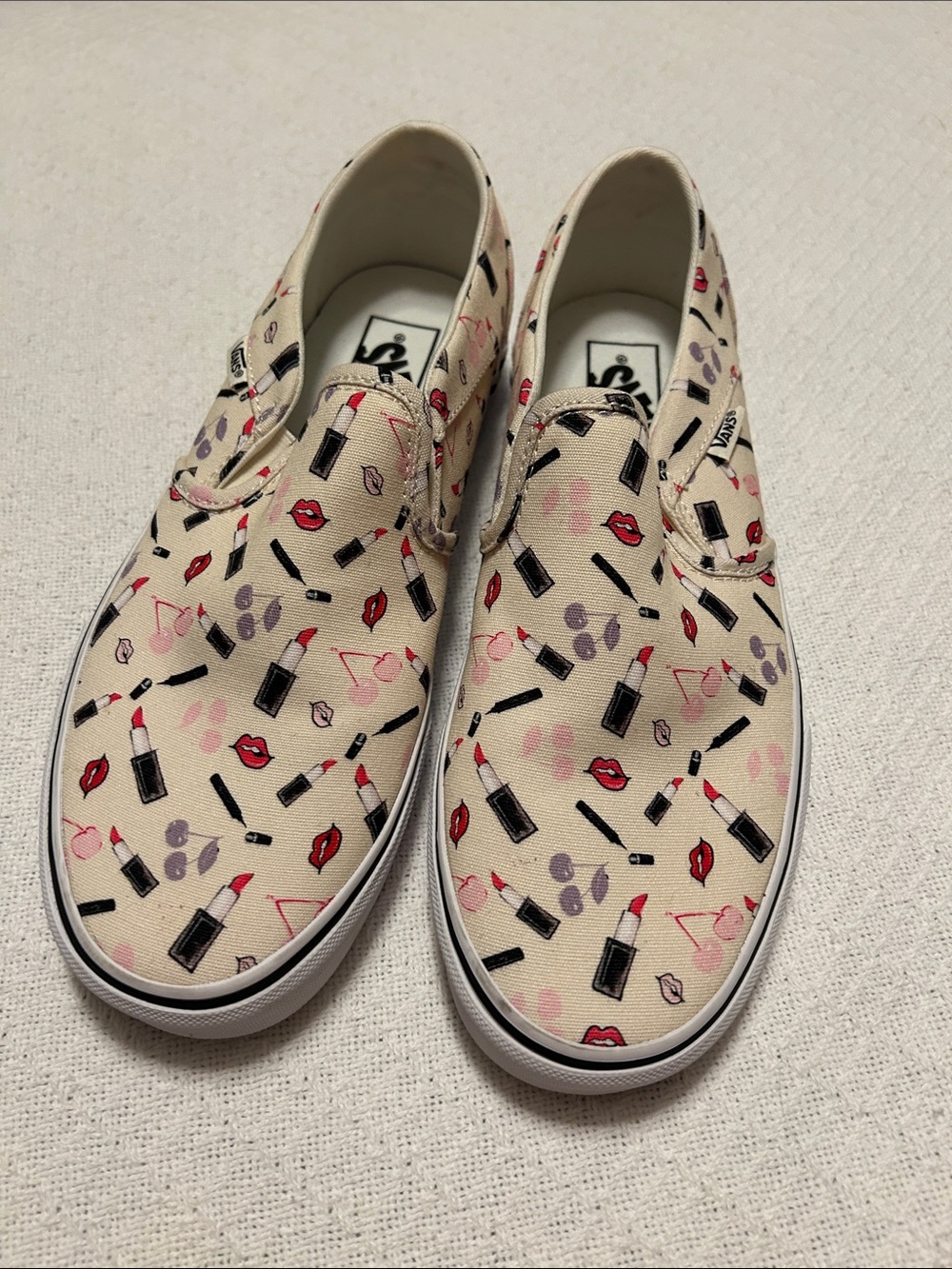 Vans Women's Slip-On Sneakers in Cream with lipstick/make-up Red & Pink Accent.